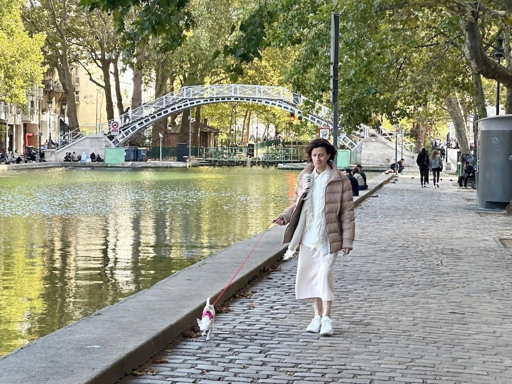 Women walking dog by canal